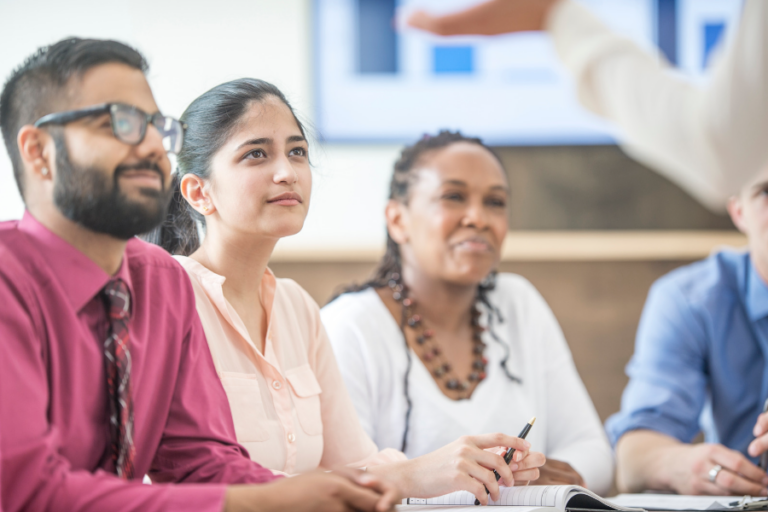 A group of 4 sitting and listening to a seminar.